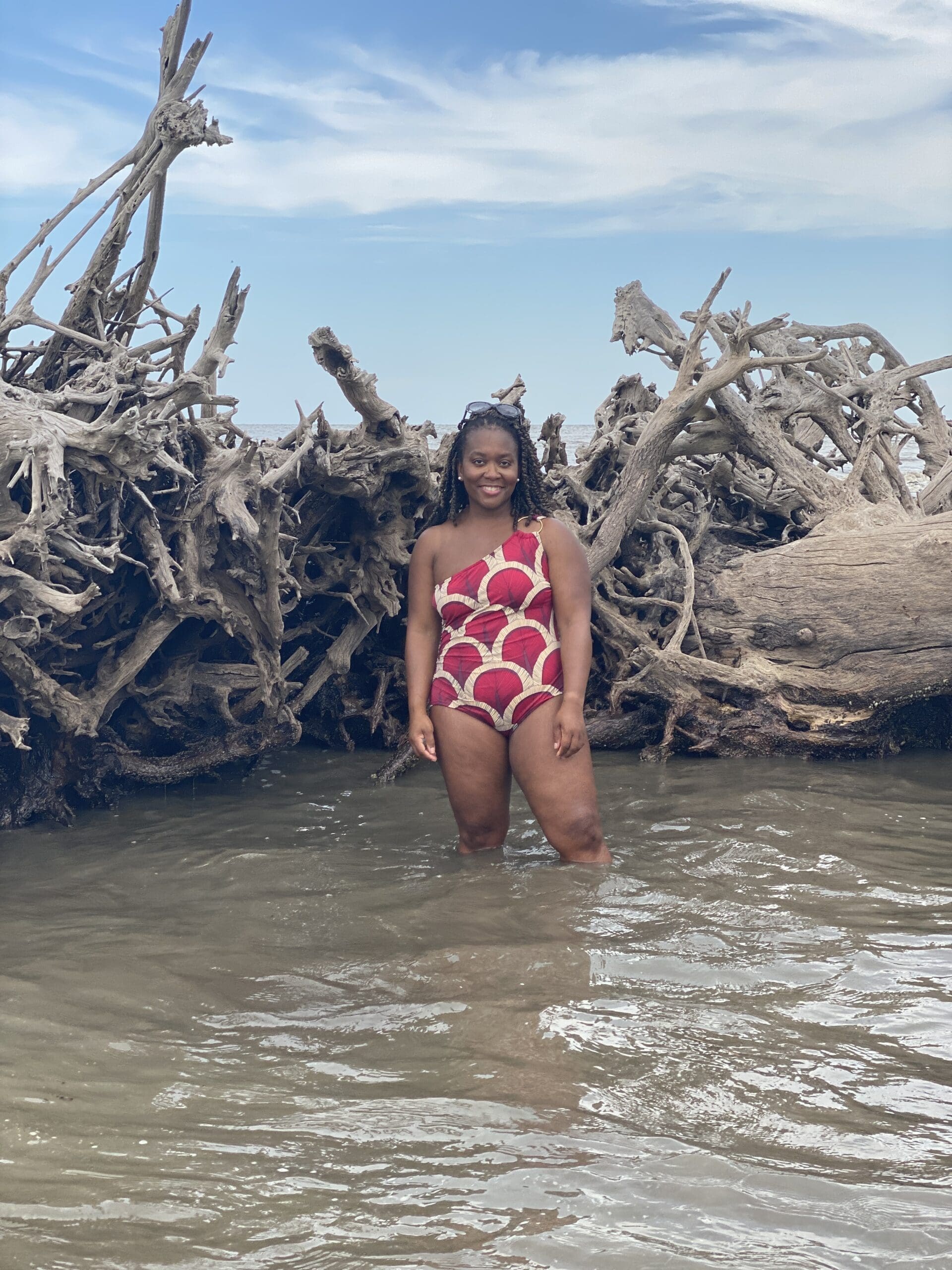 African American woman with crochet braids on Driftwood beach in Vogue 9192 swim suit