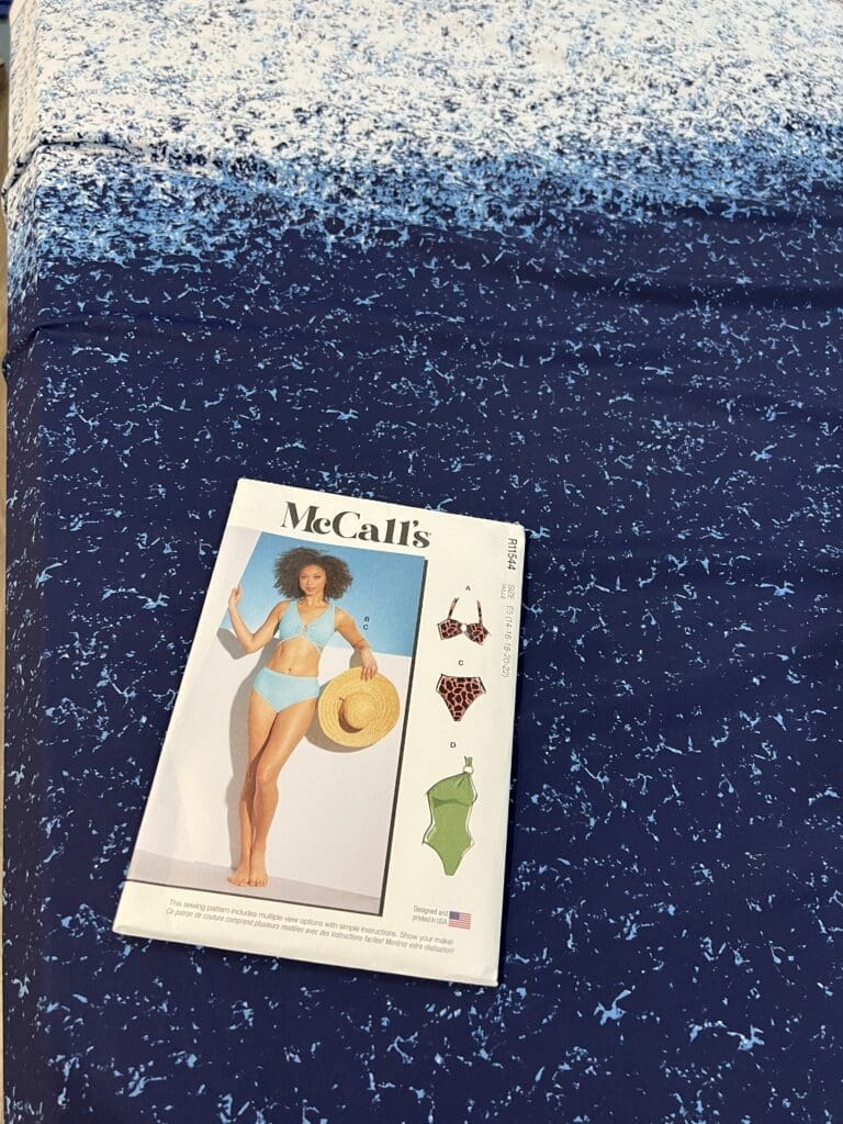 McCalls 8329 swimwear pattern on top of ombre blue lycra