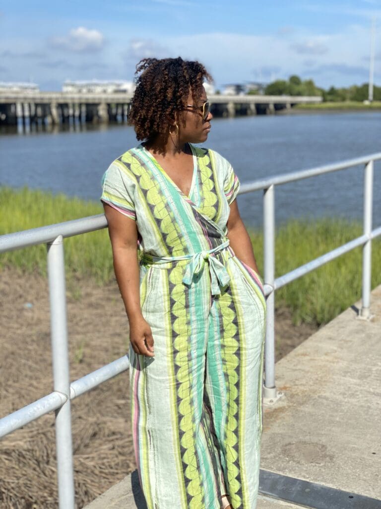 African American woman wearing the zadie jumpsuit by paper theory outside
