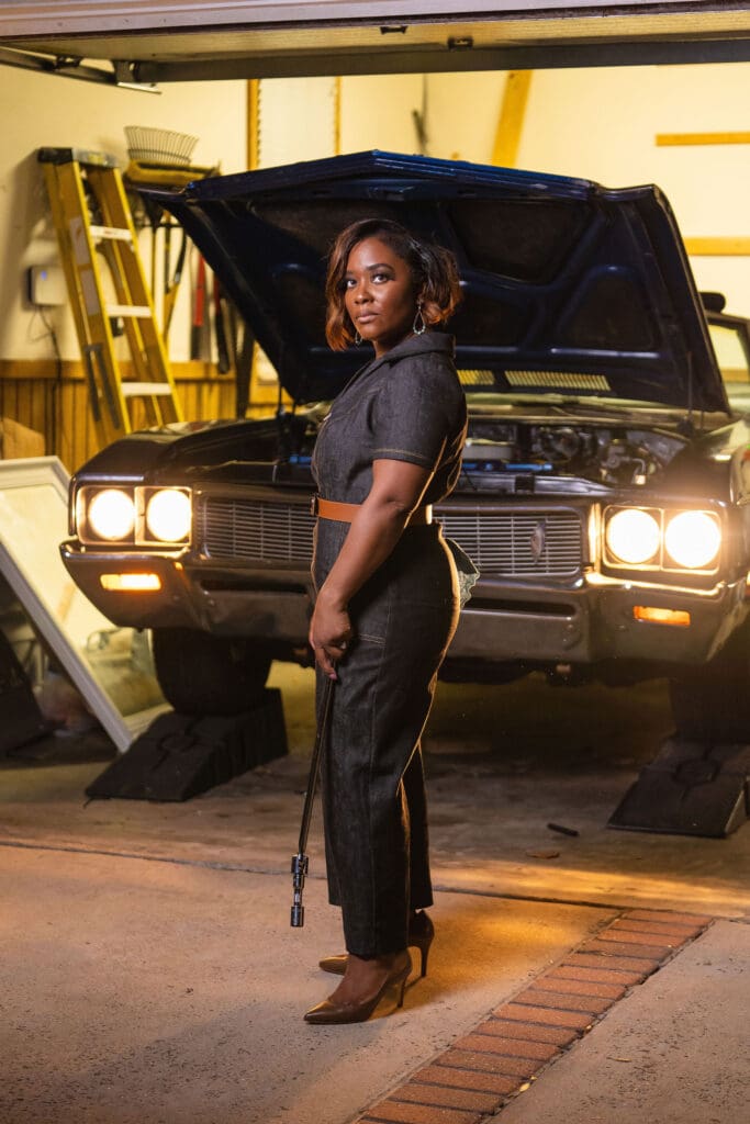 African American women holding car tool in front of car wearing McCalls7908