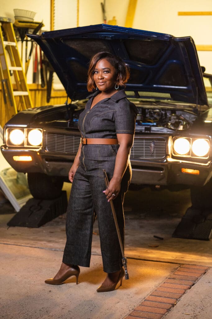 African American women holding car tool in front of car wearing McCalls7908