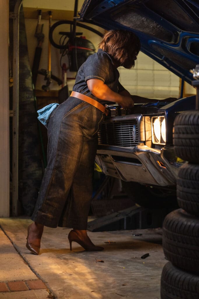 African American women working on car wearing McCalls7908