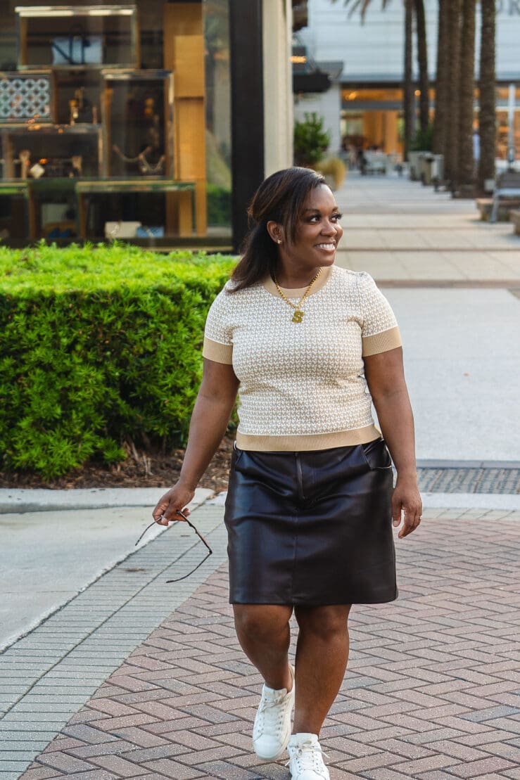 African-American woman walking at the mall in a Michael Kors short-sleeved sweater wearing McCall's 8149